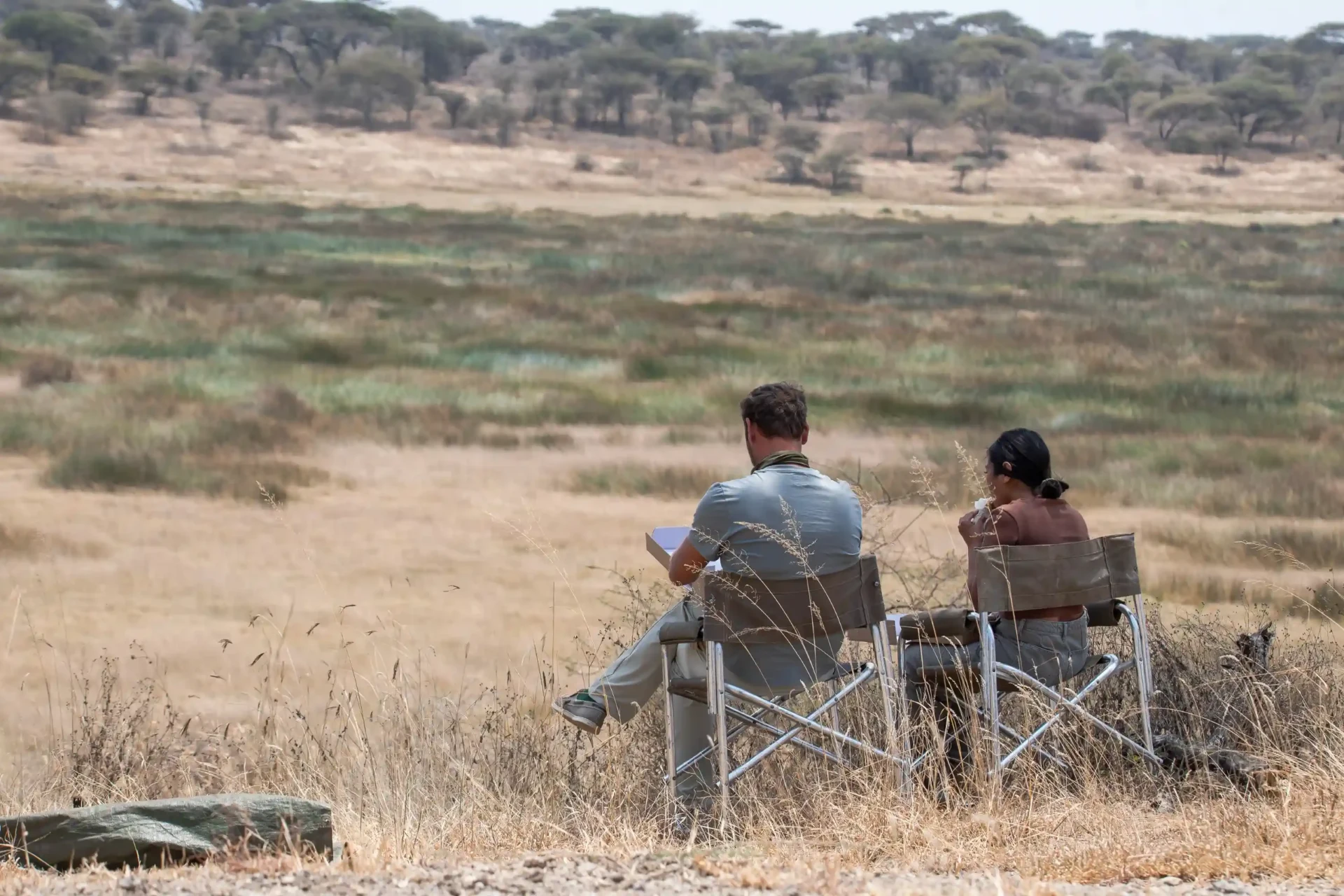Mawe African Ventures guests enjoying a quiet safari moment overlooking the Serengeti